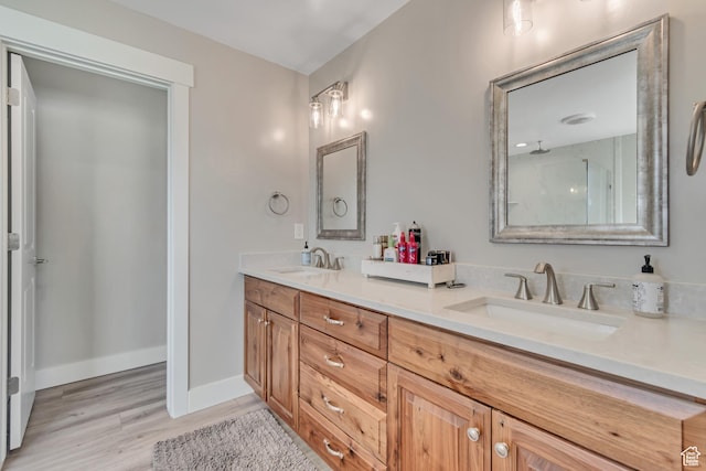 719 E Center St, Genola, UT 84655 - full bath featuring double vanity, wood finished floors, a shower, and baseboards