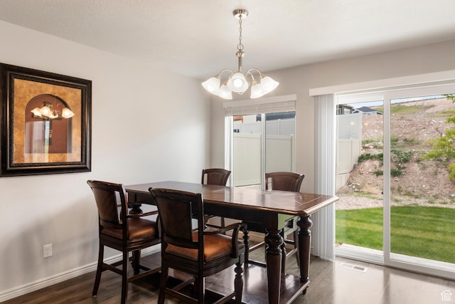 1788 S Longview Rd Unit 161, Santaquin, UT 84655 - dining area with a chandelier, dark wood-type flooring, and baseboards