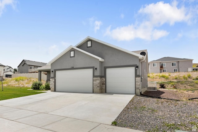 1788 S Longview Rd Unit 161, Santaquin, UT 84655 - view of front of property with a garage, stucco siding, concrete driveway, stone siding, and a front lawn