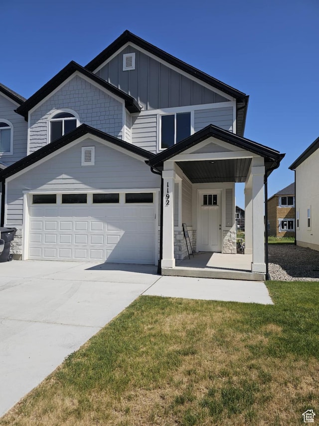 1192 W 1130 S Unit 202, Payson, UT 84651 - view of front facade featuring board and batten siding, driveway, covered porch, and an attached garage