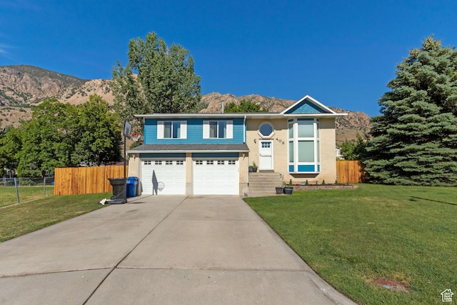 408 E 850 N, Brigham City, UT 84302 - view of front of home featuring concrete driveway, an attached garage, and a mountain view