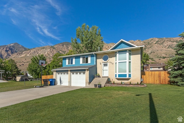 408 E 850 N, Brigham City, UT 84302 - view of front of house with a mountain view, driveway, an attached garage, and brick siding