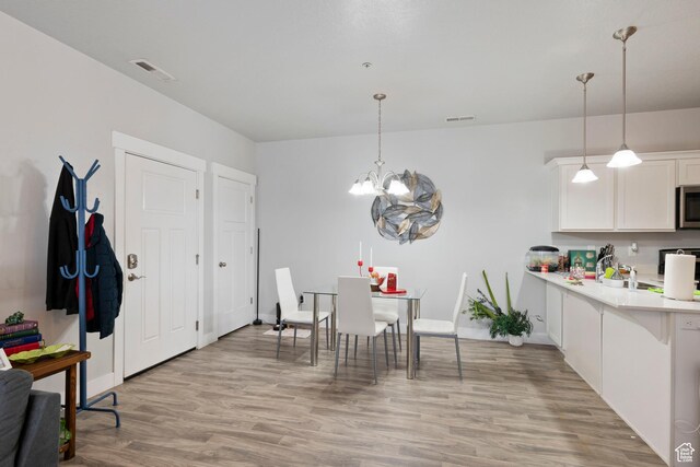 633 N Sun Peak Dr, Vineyard, UT 84059 - dining room featuring light wood-style flooring and a chandelier