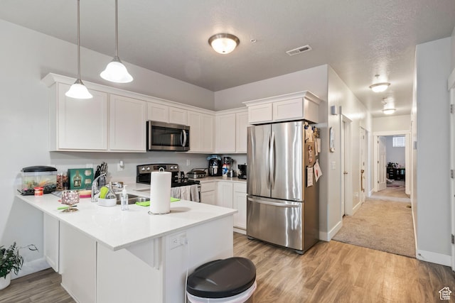 633 N Sun Peak Dr, Vineyard, UT 84059 - kitchen featuring appliances with stainless steel finishes, a peninsula, white cabinetry, light wood-style floors, and light countertops