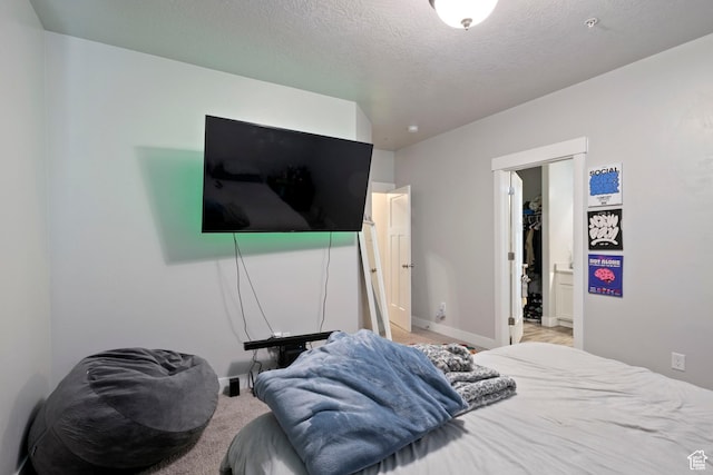 633 N Sun Peak Dr, Vineyard, UT 84059 - bedroom featuring baseboards, light colored carpet, a textured ceiling, and a spacious closet