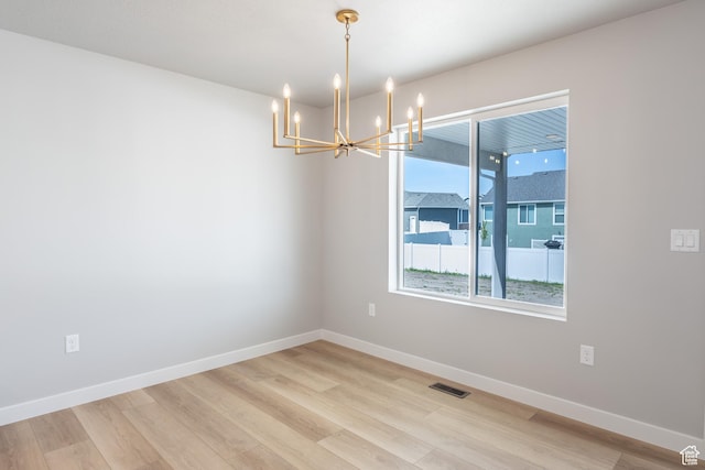3087 N 2875 W Unit 4, Plain City, UT 84404 - empty room with a chandelier and light wood finished floors