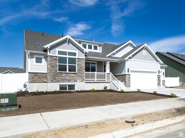 3087 N 2875 W Unit 4, Plain City, UT 84404 - craftsman house with stone siding, a porch, board and batten siding, and a garage