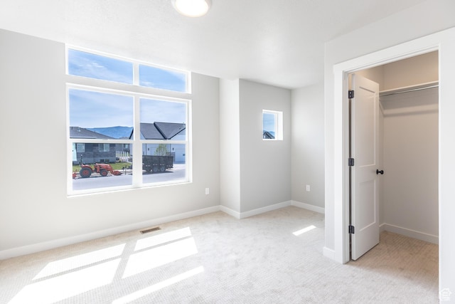 3087 N 2875 W Unit 4, Plain City, UT 84404 - unfurnished bedroom featuring light colored carpet and a spacious closet