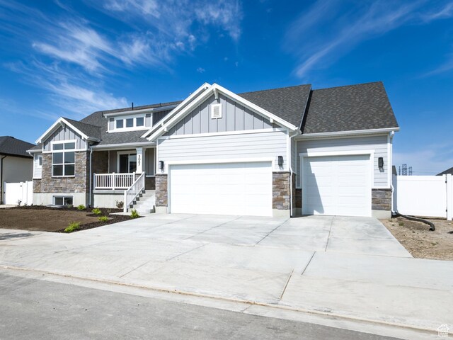 3087 N 2875 W Unit 4, Plain City, UT 84404 - craftsman-style house with stone siding, an attached garage, covered porch, and board and batten siding