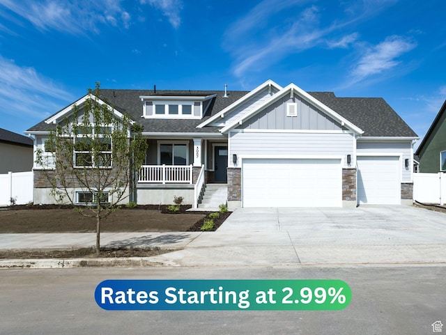 3087 N 2875 W Unit 4, Plain City, UT 84404 - view of front of property with an attached garage, stone siding, covered porch, driveway, and roof with shingles