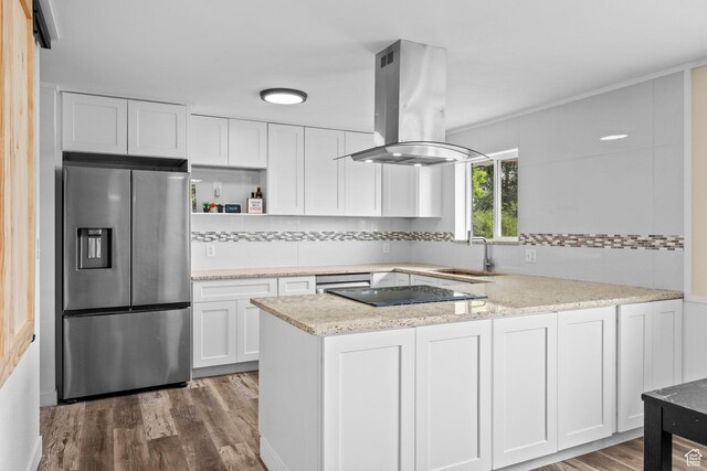 12345 S Redwood Rd, Riverton, UT 84065 - kitchen with appliances with stainless steel finishes, a sink, island range hood, white cabinets, and decorative backsplash