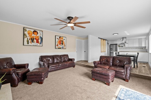 12345 S Redwood Rd, Riverton, UT 84065 - living room featuring light carpet, a ceiling fan, wainscoting, and ornamental molding
