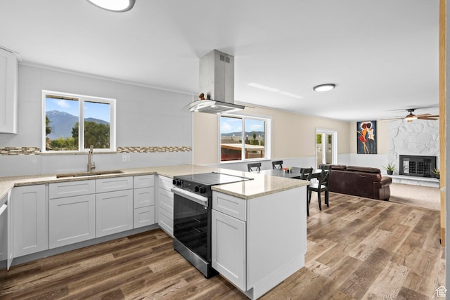12345 S Redwood Rd, Riverton, UT 84065 - kitchen featuring range with electric stovetop, a sink, island range hood, a peninsula, and dark wood-type flooring