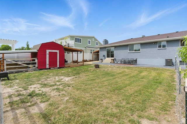 12345 S Redwood Rd, Riverton, UT 84065 - back of property featuring a patio area, a chimney, central AC, and brick siding