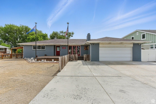12345 S Redwood Rd, Riverton, UT 84065 - ranch-style home featuring a garage, a chimney, concrete driveway, and brick siding