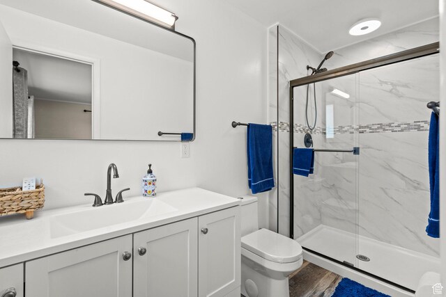 12345 S Redwood Rd, Riverton, UT 84065 - full bathroom with a marble finish shower, vanity, toilet, and wood finished floors