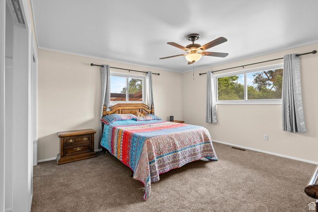 12345 S Redwood Rd, Riverton, UT 84065 - carpeted bedroom featuring multiple windows, baseboards, crown molding, and ceiling fan