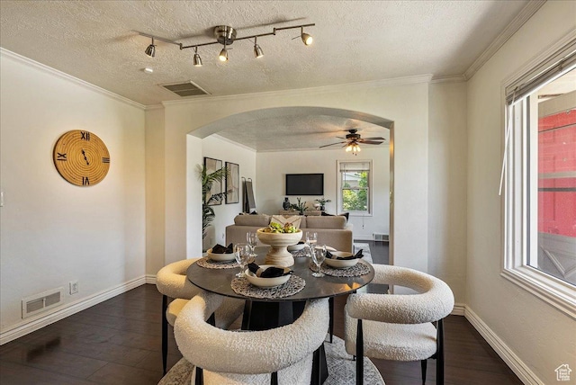 6 W Miller St S, Salt Lake City, UT 84107 - dining room with arched walkways, dark wood-type flooring, a textured ceiling, ceiling fan, and crown molding