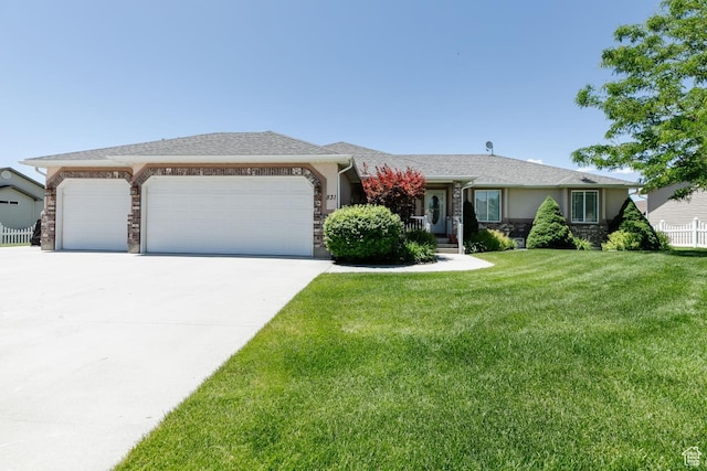 831 S 1150 E, Preston, ID 83263 - ranch-style house with a garage, driveway, a front yard, stone siding, and stucco siding