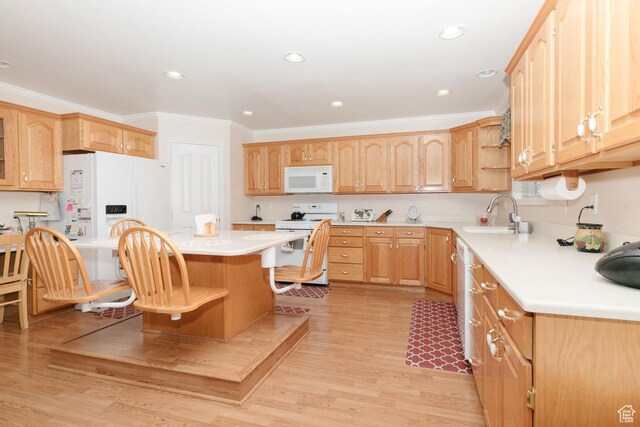831 S 1150 E, Preston, ID 83263 - kitchen featuring white appliances, a sink, ornamental molding, light countertops, and a kitchen breakfast bar