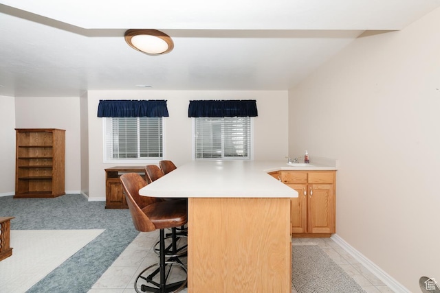 831 S 1150 E, Preston, ID 83263 - kitchen featuring a kitchen bar, light countertops, a peninsula, and light tile patterned flooring
