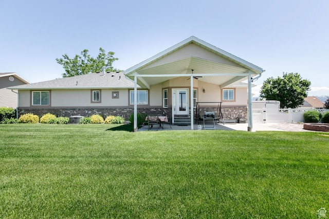 831 S 1150 E, Preston, ID 83263 - rear view of property with stucco siding, ceiling fan, a patio area, and stone siding