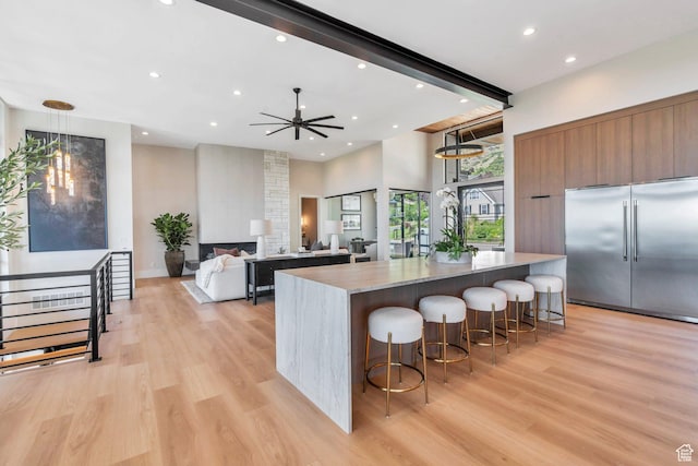 3943 N Foothill Dr, Provo, UT 84604 - kitchen featuring stainless steel built in refrigerator, modern cabinets, recessed lighting, light wood finished floors, and a kitchen breakfast bar