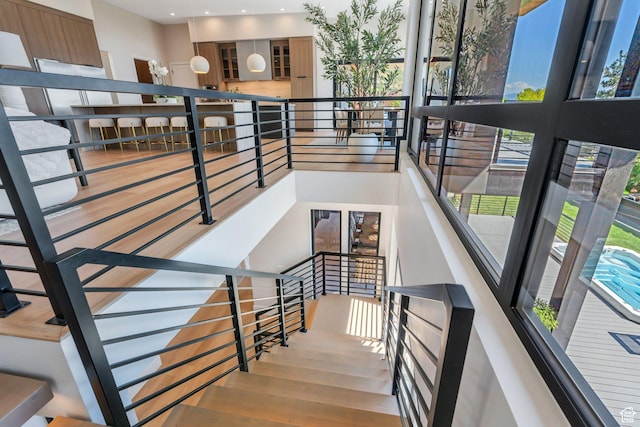 3943 N Foothill Dr, Provo, UT 84604 - staircase with wood finished floors, a towering ceiling, and recessed lighting