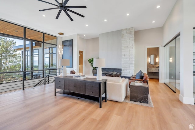 3943 N Foothill Dr, Provo, UT 84604 - living area with a ceiling fan, light wood finished floors, floor to ceiling windows, a fireplace, and recessed lighting