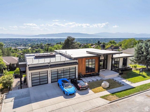 3943 N Foothill Dr, Provo, UT 84604 - contemporary home with a mountain view, a balcony, concrete driveway, and a garage
