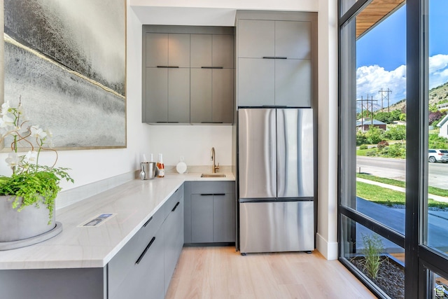 3943 N Foothill Dr, Provo, UT 84604 - kitchen with gray cabinetry, stainless steel refrigerator, modern cabinets, and a sink