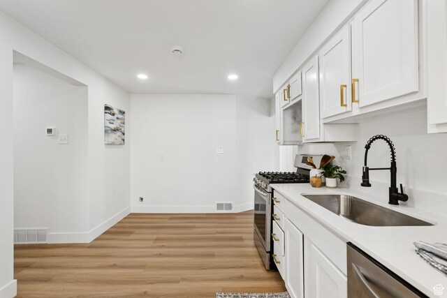155 W 800 N, Spanish Fork, UT 84660 - kitchen featuring appliances with stainless steel finishes, a sink, recessed lighting, light countertops, and white cabinetry