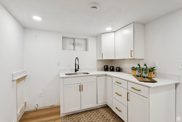 155 W 800 N, Spanish Fork, UT 84660 - kitchen featuring a sink, light countertops, white cabinets, recessed lighting, and light wood-style floors