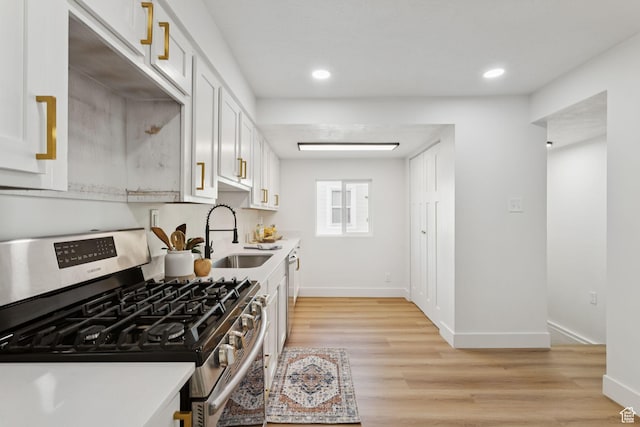 155 W 800 N, Spanish Fork, UT 84660 - kitchen with stainless steel appliances, a sink, light countertops, light wood-style flooring, and baseboards