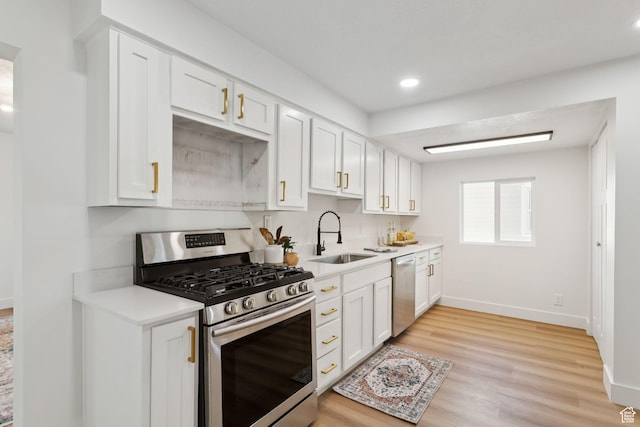 155 W 800 N, Spanish Fork, UT 84660 - kitchen featuring stainless steel appliances, a sink, light countertops, baseboards, and white cabinetry