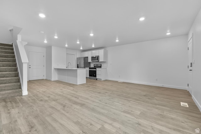 1895 S 530 W Unit 1193, Provo, UT 84601 - unfurnished living room featuring recessed lighting, baseboards, stairway, and light wood finished floors