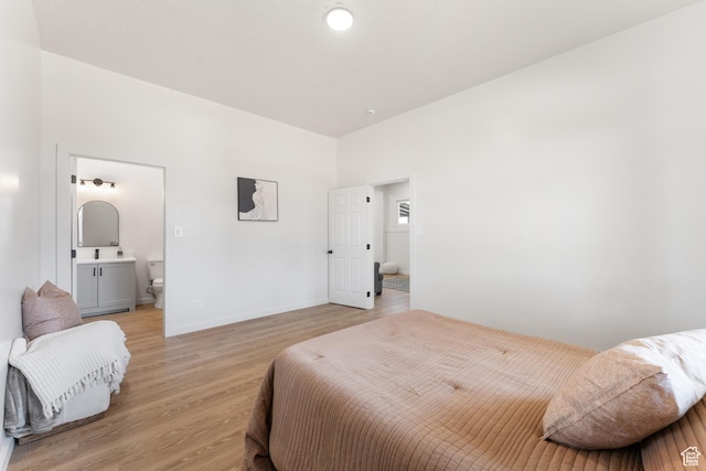 2802 W 5600 S, Roy, UT 84067 - bedroom with light wood-type flooring, connected bathroom, and baseboards