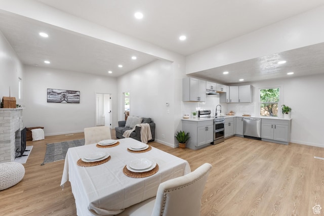 2802 W 5600 S, Roy, UT 84067 - dining space featuring recessed lighting, light wood-style flooring, baseboards, and a fireplace