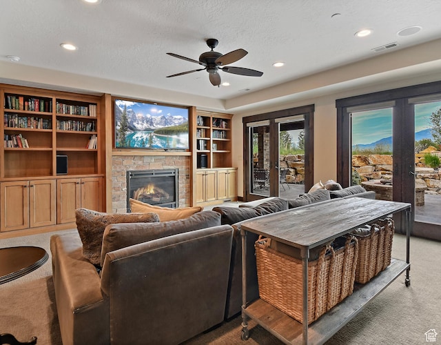 707 N Chimney Rock Rd, Heber City, UT 84032 - living room with light carpet, a stone fireplace, ceiling fan, recessed lighting, and a textured ceiling