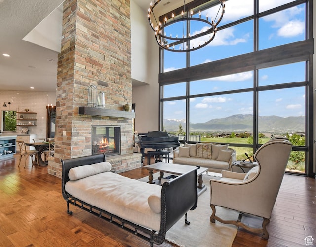 707 N Chimney Rock Rd, Heber City, UT 84032 - living room featuring a high ceiling, a chandelier, a mountain view, wood-type flooring, and a multi sided fireplace