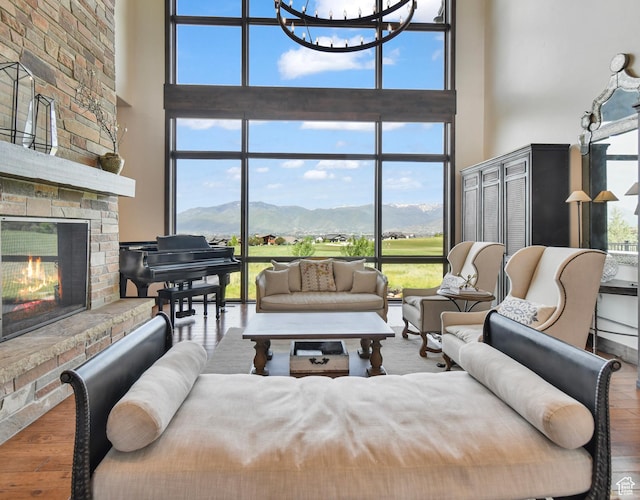 707 N Chimney Rock Rd, Heber City, UT 84032 - living room featuring a towering ceiling, a large fireplace, a mountain view, healthy amount of natural light, and a wall of windows