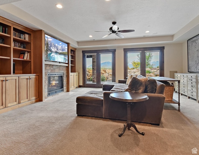 707 N Chimney Rock Rd, Heber City, UT 84032 - living area with light carpet, a textured ceiling, a fireplace, a ceiling fan, and recessed lighting