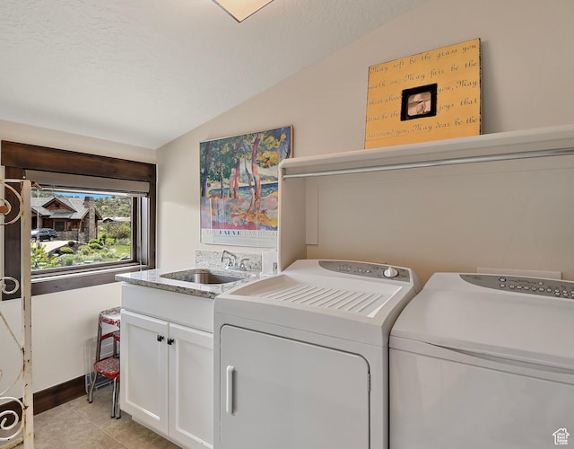 707 N Chimney Rock Rd, Heber City, UT 84032 - laundry area with cabinet space, washing machine and dryer, light tile patterned floors, and a textured ceiling
