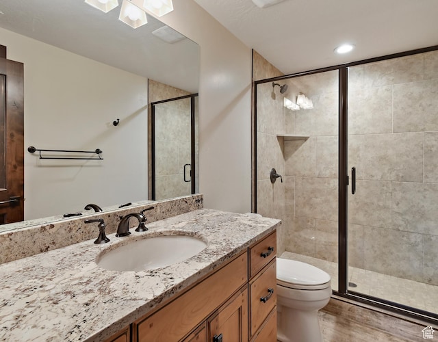707 N Chimney Rock Rd, Heber City, UT 84032 - full bathroom featuring vanity, toilet, a stall shower, and wood finished floors