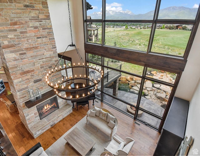 707 N Chimney Rock Rd, Heber City, UT 84032 - living area with a high ceiling, healthy amount of natural light, a glass covered fireplace, a chandelier, and wood finished floors