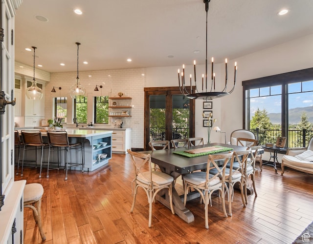 707 N Chimney Rock Rd, Heber City, UT 84032 - dining room with light wood finished floors, recessed lighting, and brick wall