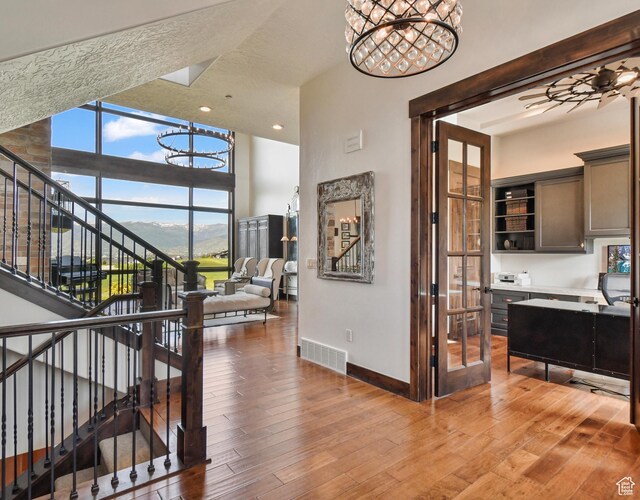 707 N Chimney Rock Rd, Heber City, UT 84032 - stairs with a chandelier, baseboards, hardwood / wood-style floors, recessed lighting, and a high ceiling