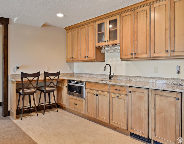 707 N Chimney Rock Rd, Heber City, UT 84032 - kitchen featuring stainless steel oven, a sink, a textured ceiling, light stone countertops, and brown cabinets