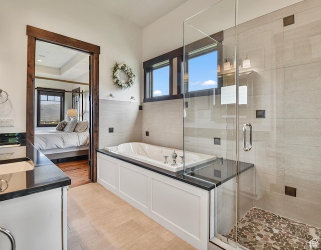 707 N Chimney Rock Rd, Heber City, UT 84032 - ensuite bathroom featuring a bath, vanity, a shower stall, tile walls, and tile patterned flooring