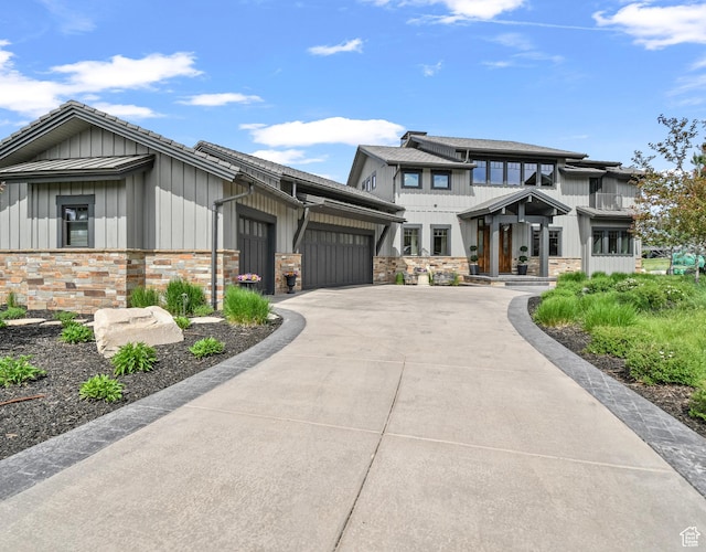 707 N Chimney Rock Rd, Heber City, UT 84032 - view of front of property with board and batten siding, an attached garage, concrete driveway, and stone siding